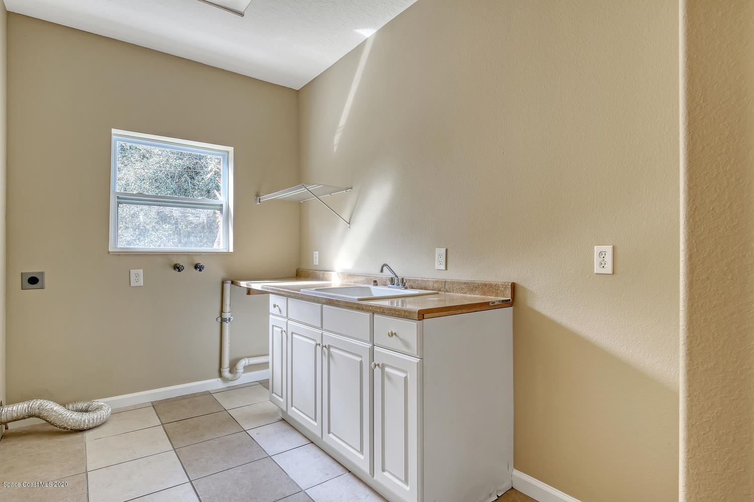 1290 Adamson Road Cocoa, FL 32926 - Photo 32 of 38 Large Indoor Laundry Room With Room For