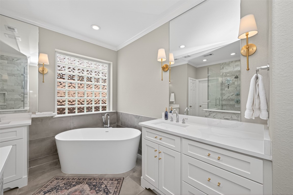 18207 Yukon Ridge Trail Humble, TX 77346 - Photo 19 of 49 The primary bathroom features a freestanding tub and a spacious double vanity.