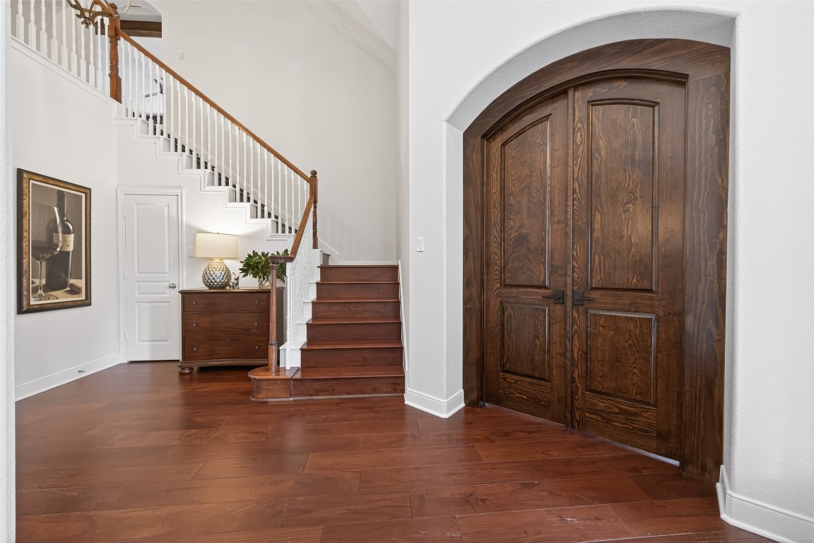 18207 Yukon Ridge Trail Humble, TX 77346 - Photo 5 of 49 This inviting entryway features elegant hardwood floors and a grand staircase and high ceilings. The beautiful double doors lead to the office space.