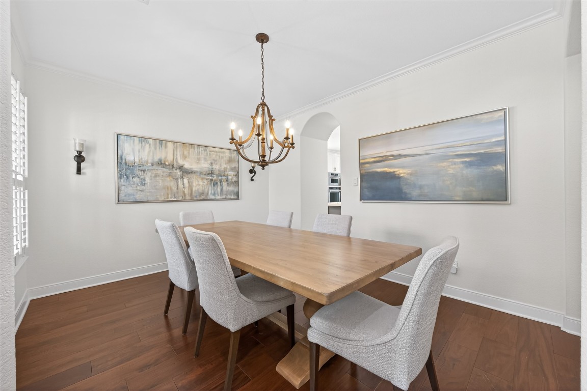 18207 Yukon Ridge Trail Humble, TX 77346 - Photo 8 of 49 This dining room features a stylish chandelier and an arched doorway leads to the kitchen area.