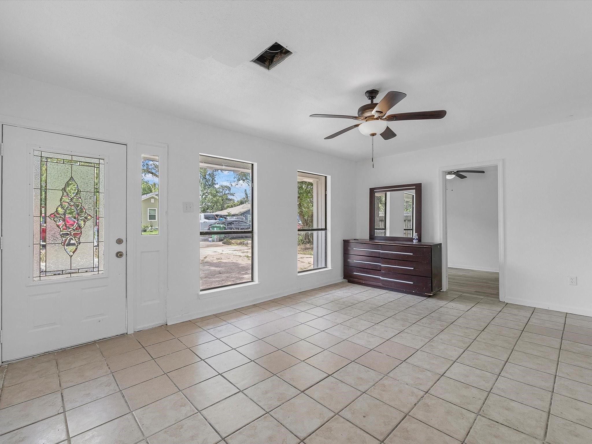8161 Record Street Houston, TX 77028 - Photo 2 of 12 a view of livingroom with furniture chandelier fan and fire place
