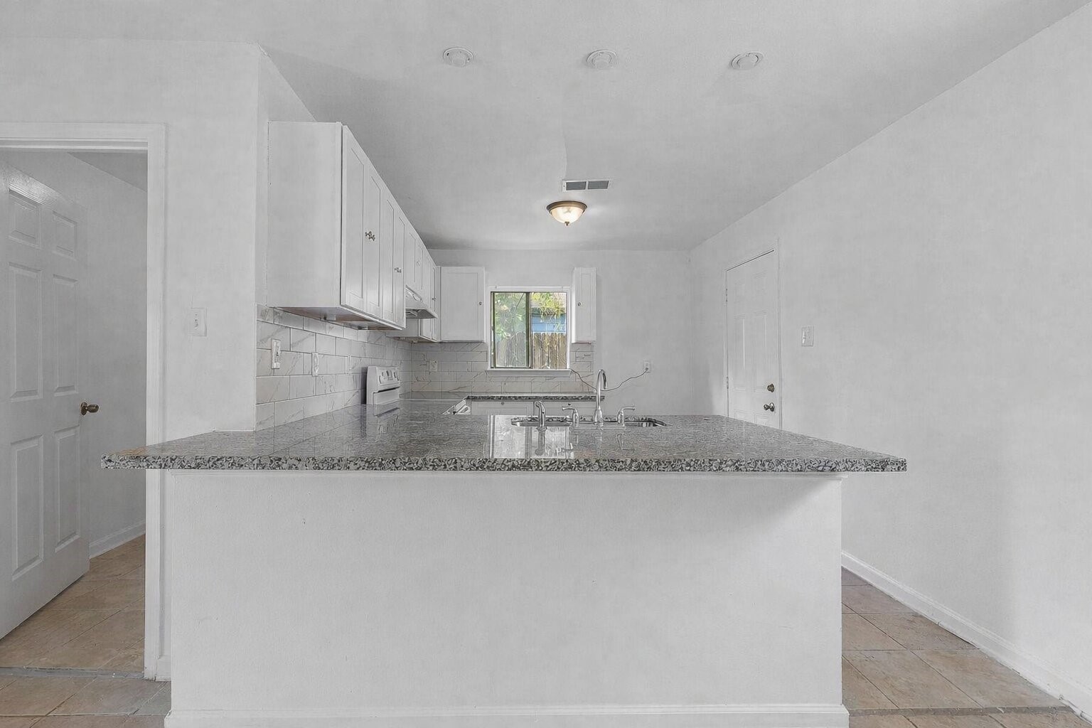8161 Record Street Houston, TX 77028 - Photo 5 of 12 a kitchen with stainless steel appliances granite countertop a sink and a granite counter tops