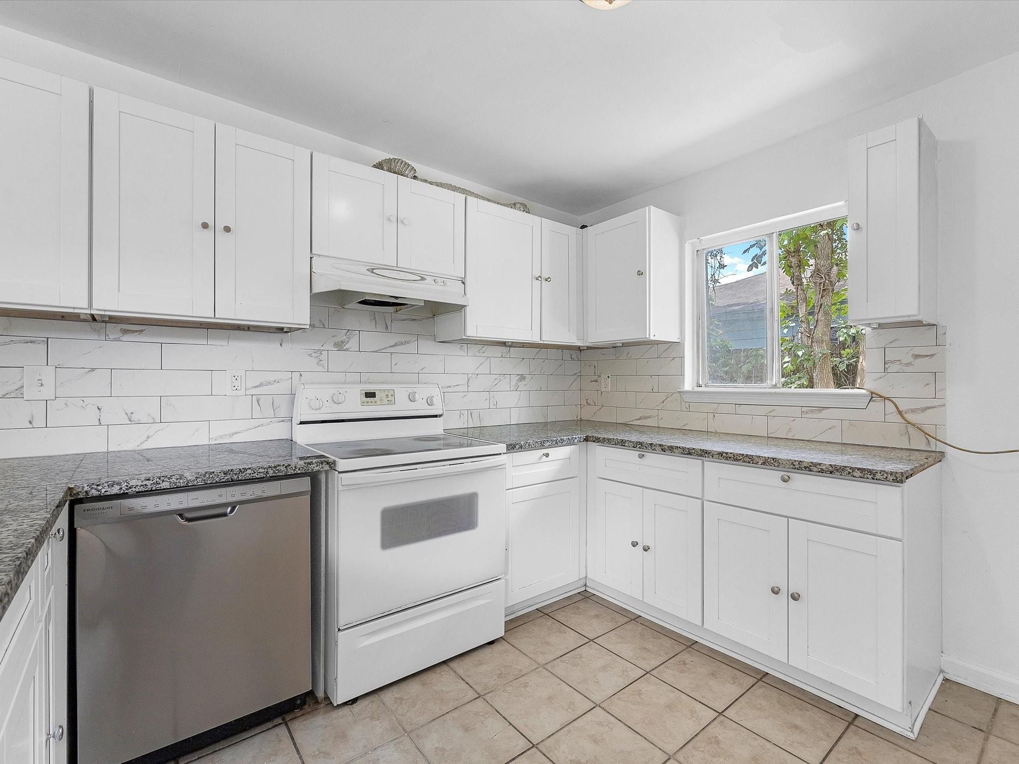 8161 Record Street Houston, TX 77028 - Photo 7 of 12 a kitchen with white cabinets white appliances and sink