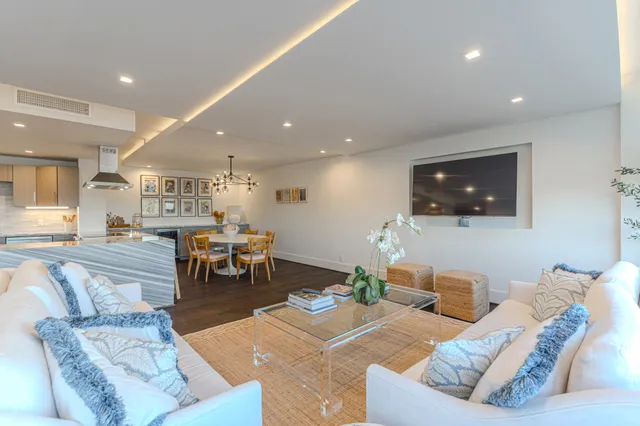a living room with fireplace furniture and a wooden floor