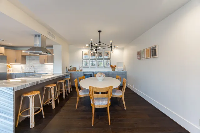 a dining room with a wooden table and chairs