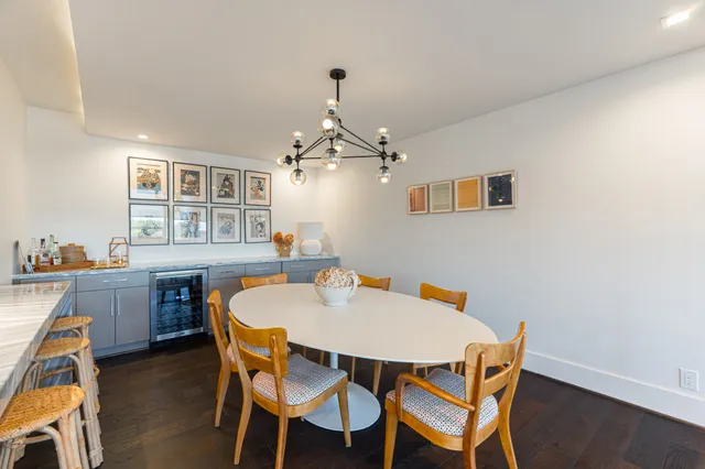 a dining table with chairs and window