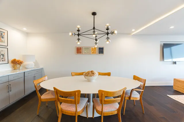 a kitchen with kitchen island a table and chairs in it