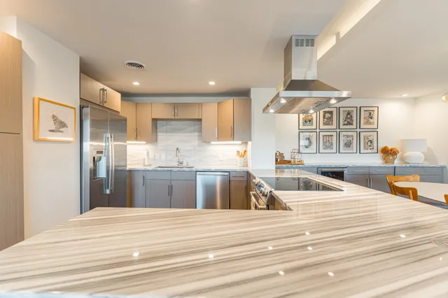 a kitchen with granite countertop a sink stove and refrigerator