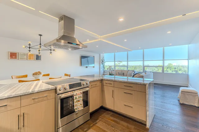 a kitchen with stainless steel appliances granite countertop a refrigerator and a sink
