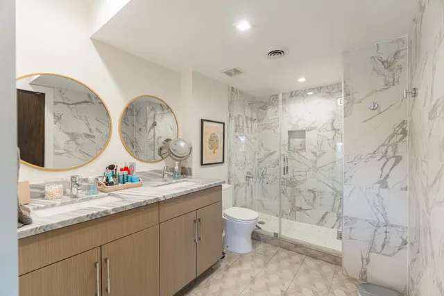 a bathroom with a granite countertop sink mirror and vanity