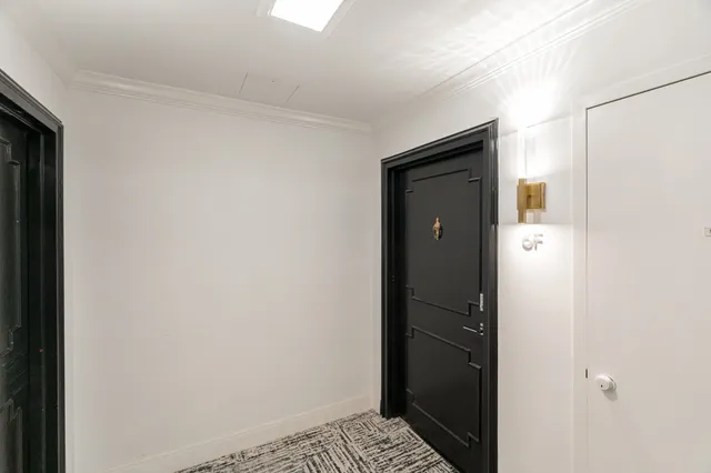 a bathroom with a toilet and a mirror