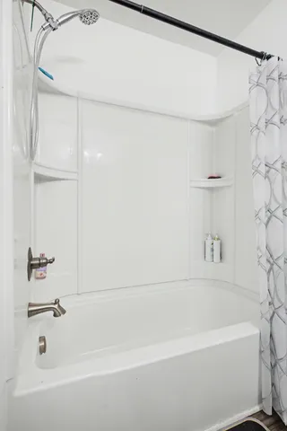 a bathroom with a bathtub and a shower