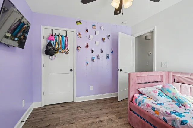 a bedroom with bed and wooden floor