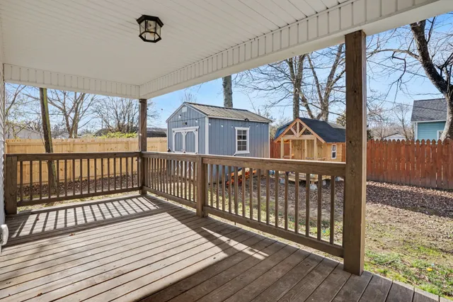 a view of a balcony with wooden floor