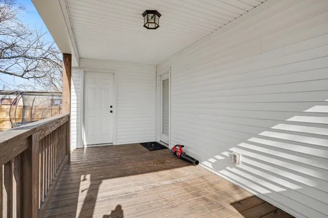 a view of a livingroom with wooden floor and staircase