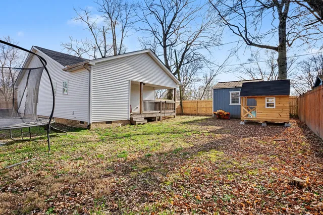 a backyard of a house with cars parked