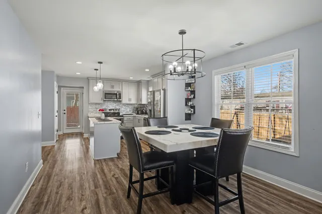 a view of a dining room with furniture window and wooden floor