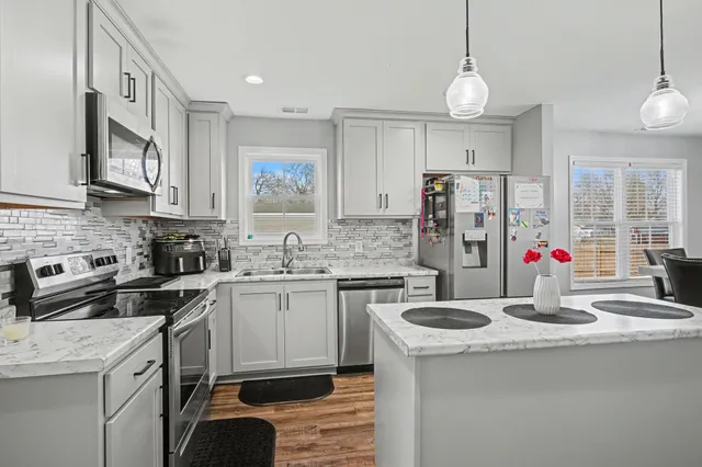 a kitchen with a sink stove and cabinets