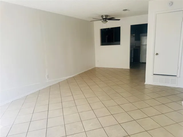 a kitchen with a refrigerator and a stove