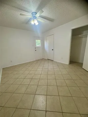 a view of a room with a fireplace and windows