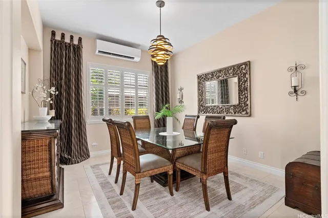 a dining room with furniture window and wooden floor