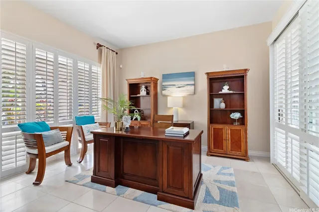a view of a workspace with furniture and a window