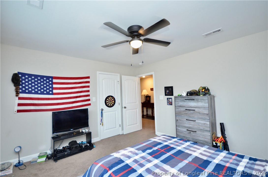 1865 John B Carter Road Fayetteville, NC 28312 - Photo 28 of 49 a bedroom with a bed and a flat screen tv