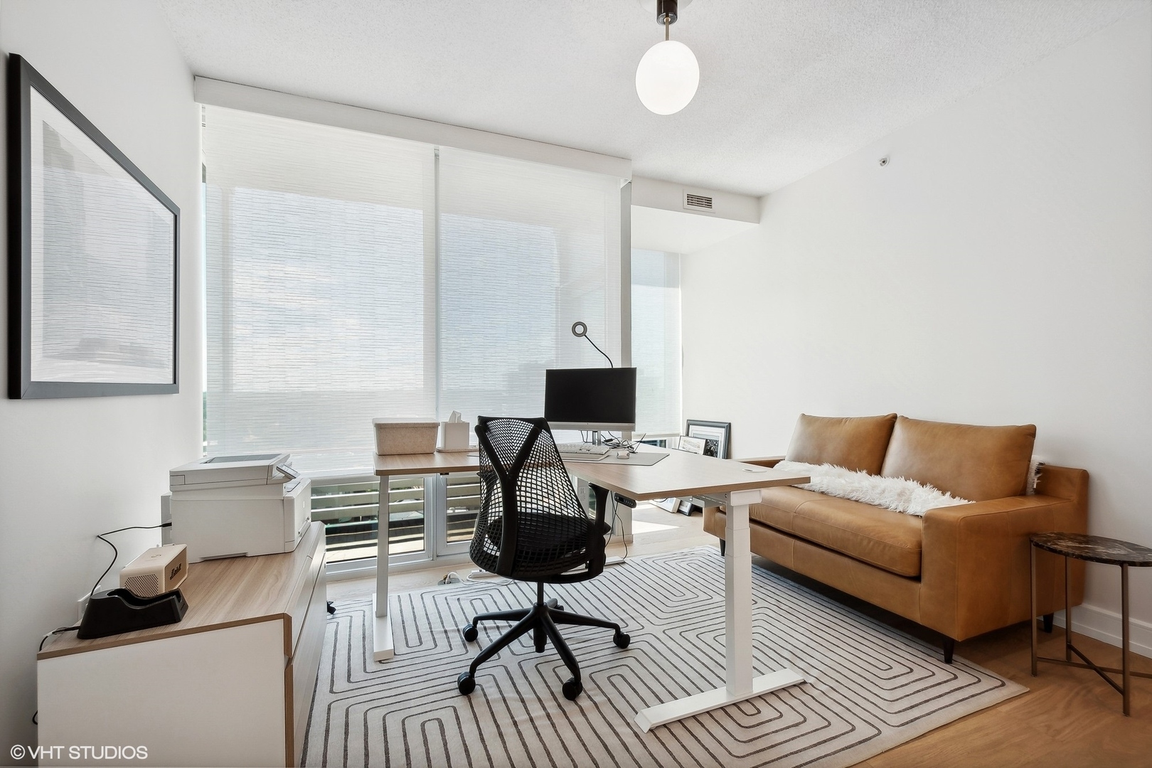 800 Elgin Road, Unit PH02 Evanston, IL 60201 - Photo 16 of 31 a living room with furniture and a wooden floor