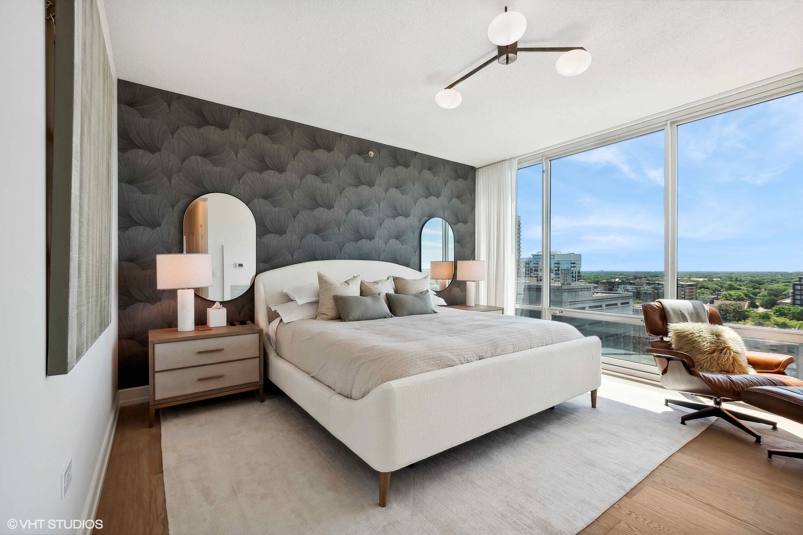 800 Elgin Road, Unit PH02 Evanston, IL 60201 - Photo 18 of 31 a spacious bedroom with a bed lamp on dresser and a large window