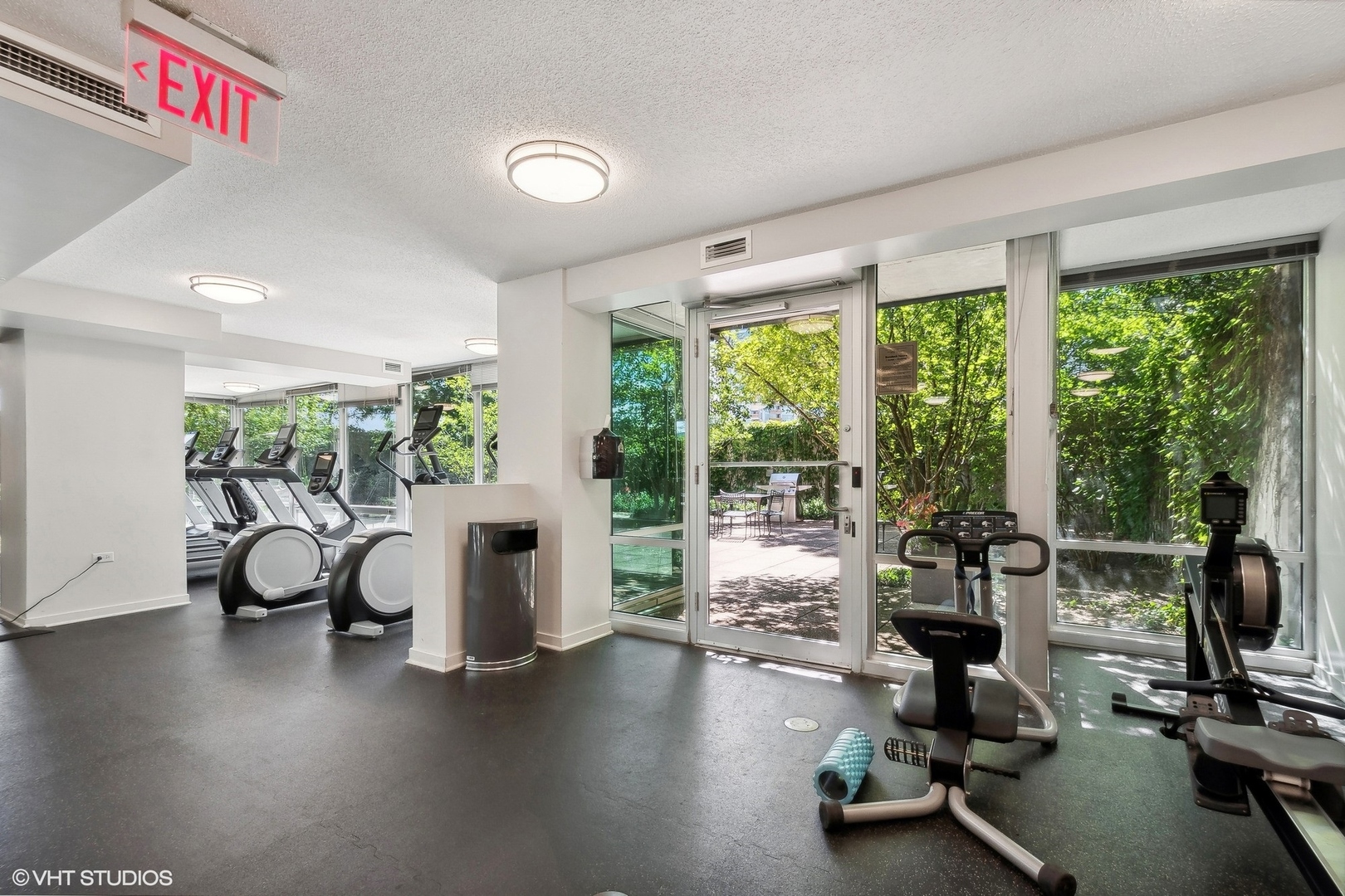 800 Elgin Road, Unit PH02 Evanston, IL 60201 - Photo 27 of 31 a living room with furniture floor to ceiling window and wooden floor