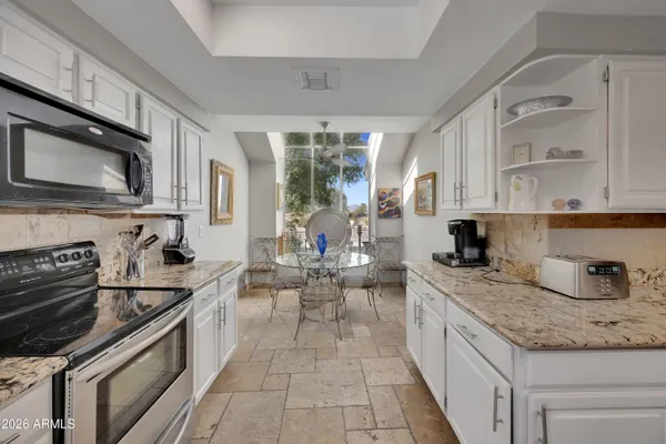 a kitchen with a stove sink and cabinets