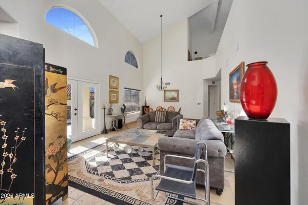 a living room with furniture a rug and white walls