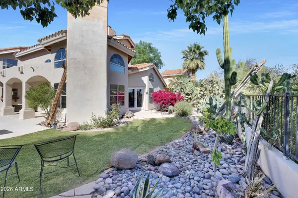 a view of a house with backyard and sitting area