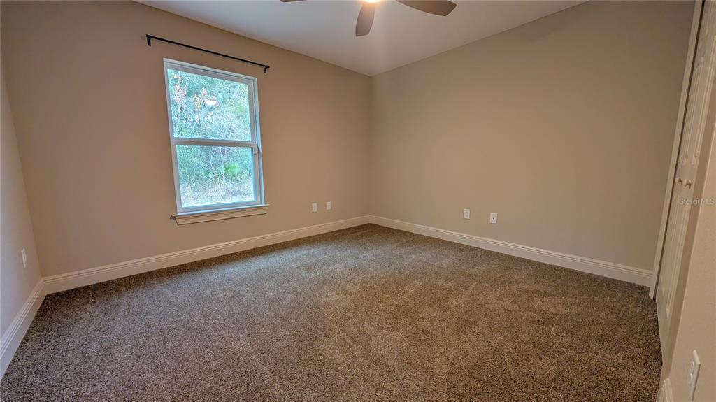 8802 Southwest 135th Place Ocala, FL 34473 - Photo 11 of 39 an empty room with a window