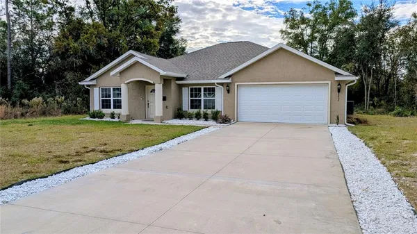 a view of a yard in front view of a house
