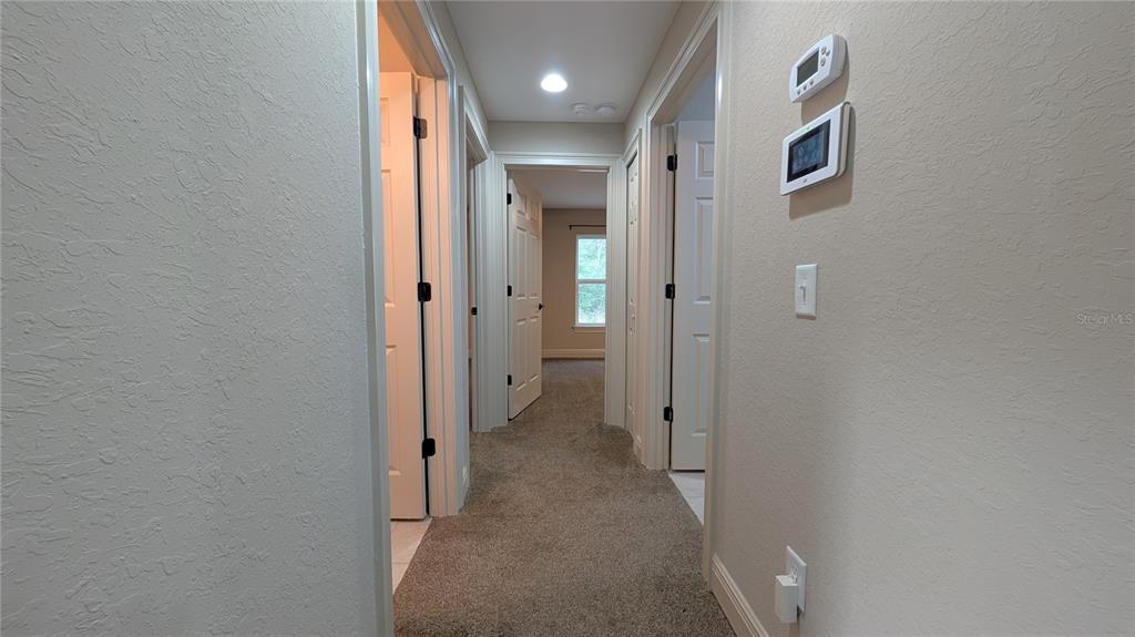 8802 Southwest 135th Place Ocala, FL 34473 - Photo 21 of 39 a view of a hallway with wooden shelves
