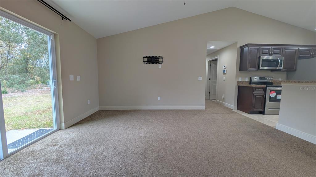 8802 Southwest 135th Place Ocala, FL 34473 - Photo 26 of 39 a view of a kitchen with refrigerator stove and a sink