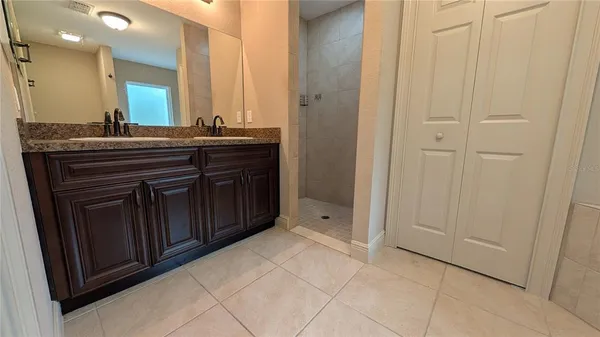 a bathroom with a granite countertop sink a mirror and a vanity