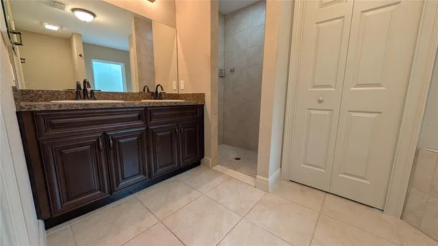 a bathroom with a granite countertop sink a mirror and a vanity
