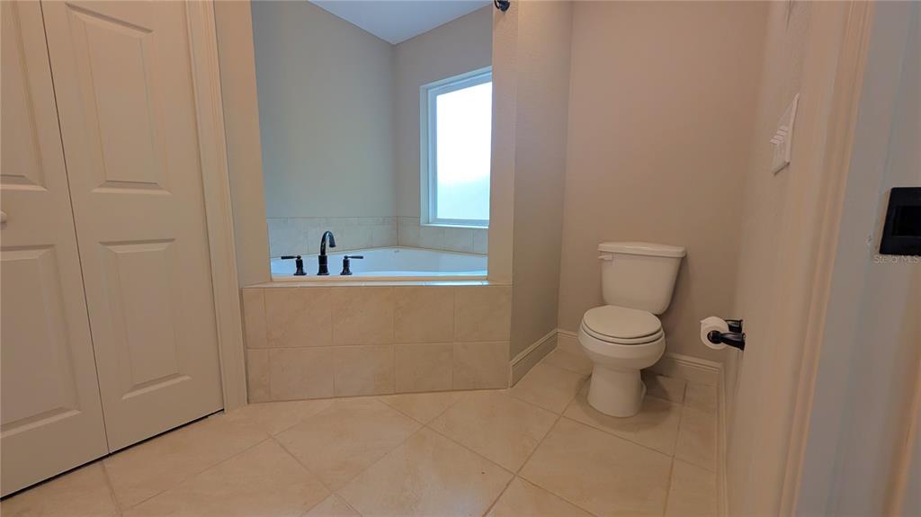 8802 Southwest 135th Place Ocala, FL 34473 - Photo 35 of 39 a white toilet sitting next to a bathroom sink