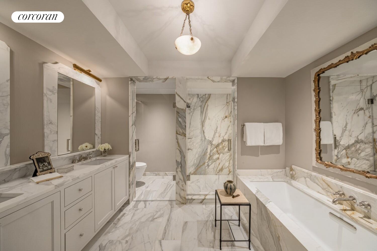 118 West 13th Street, Unit 3 Manhattan, NY 10011 - Photo 25 of 31 a spacious bathroom with a double vanity sink a mirror a bathtub and next to a window