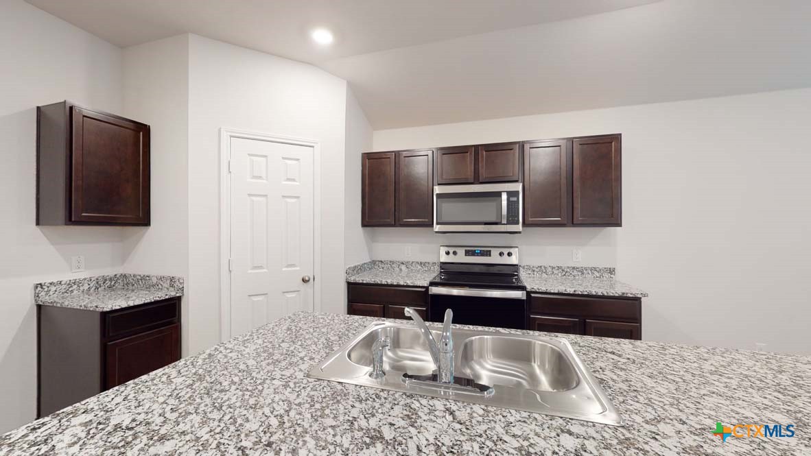 553 Hector Loop Georgetown, TX 78626 - Photo 5 of 21 a kitchen with a sink and a microwave