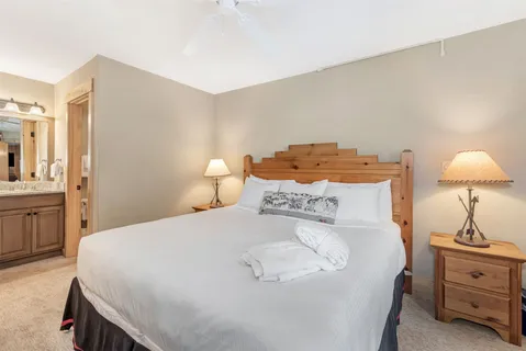 a bedroom with a bed and a lamp
