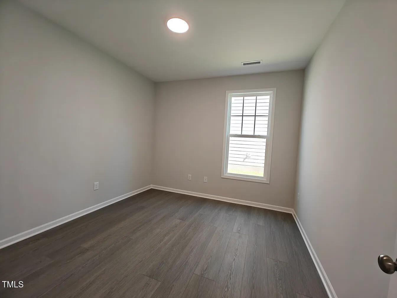 2409 Englemann Drive Apex, NC 27502 - Photo 11 of 25 an empty room with wooden floor and windows