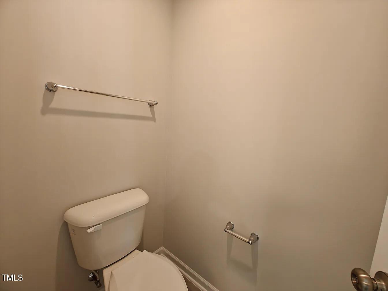 2409 Englemann Drive Apex, NC 27502 - Photo 16 of 25 a white toilet sitting next to a shower