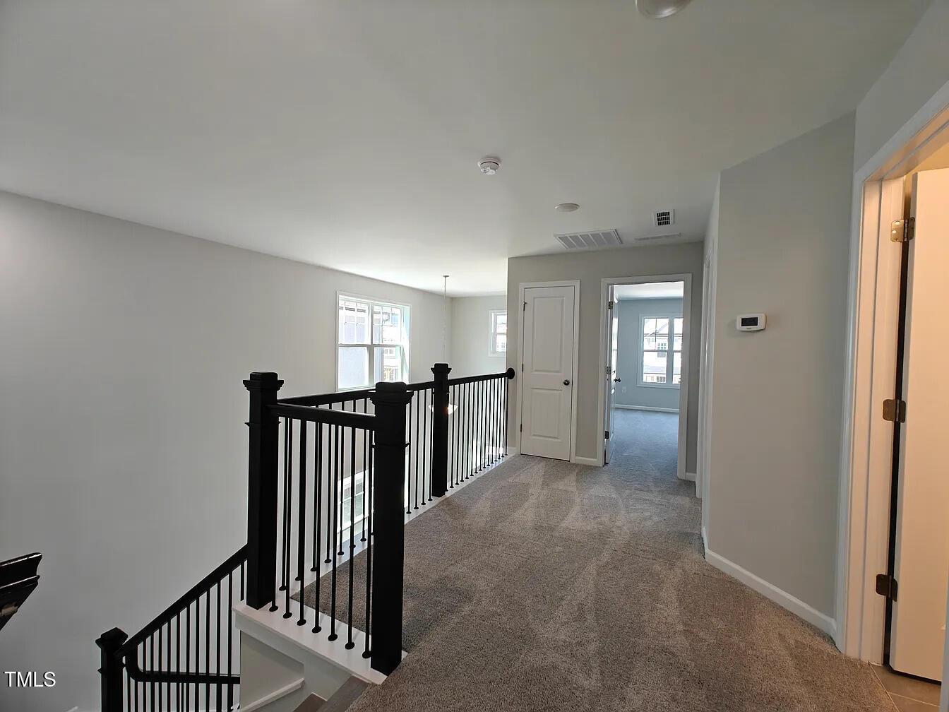 2409 Englemann Drive Apex, NC 27502 - Photo 18 of 25 a view of a hallway with windows and stairs