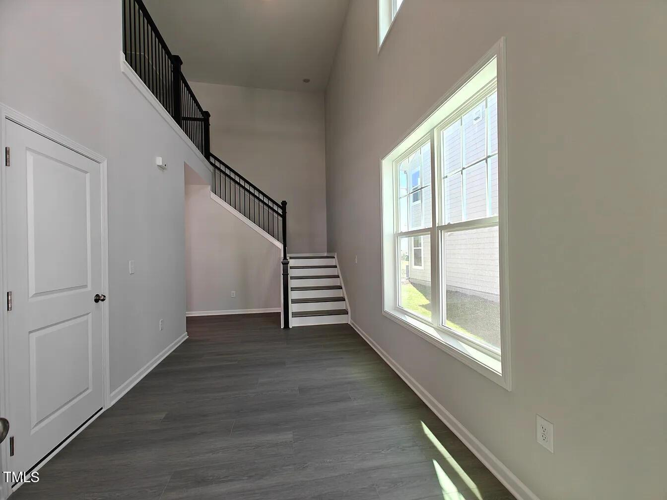2409 Englemann Drive Apex, NC 27502 - Photo 3 of 25 a view of an empty room with wooden floor and fan