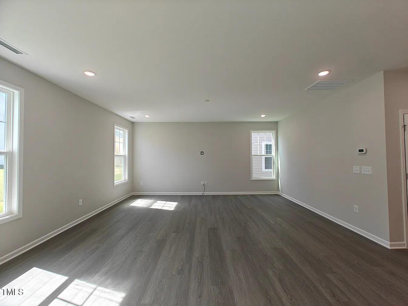2409 Englemann Drive Apex, NC 27502 - Photo 5 of 25 a view of an empty room with wooden floor and window