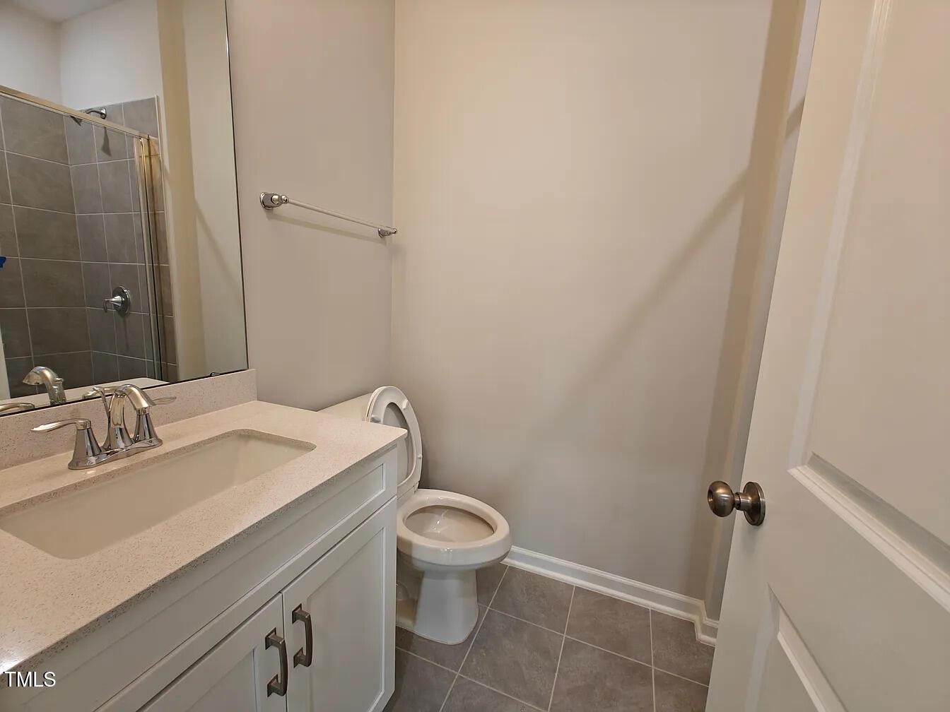 2409 Englemann Drive Apex, NC 27502 - Photo 8 of 25 a bathroom with a sink toilet and shower