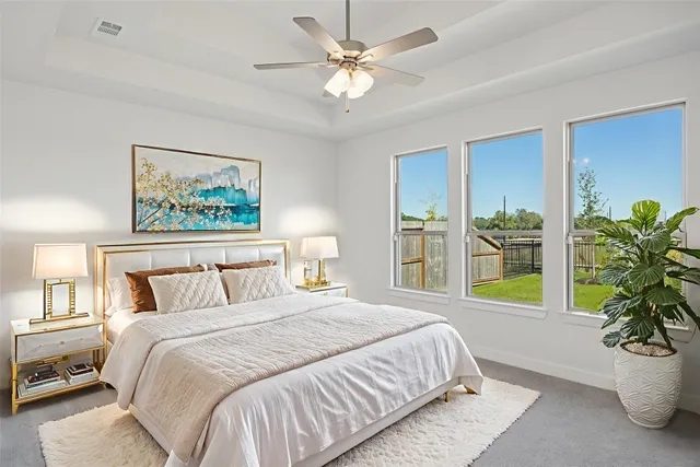 a bedroom with a balcony a bed and a painting on the wall